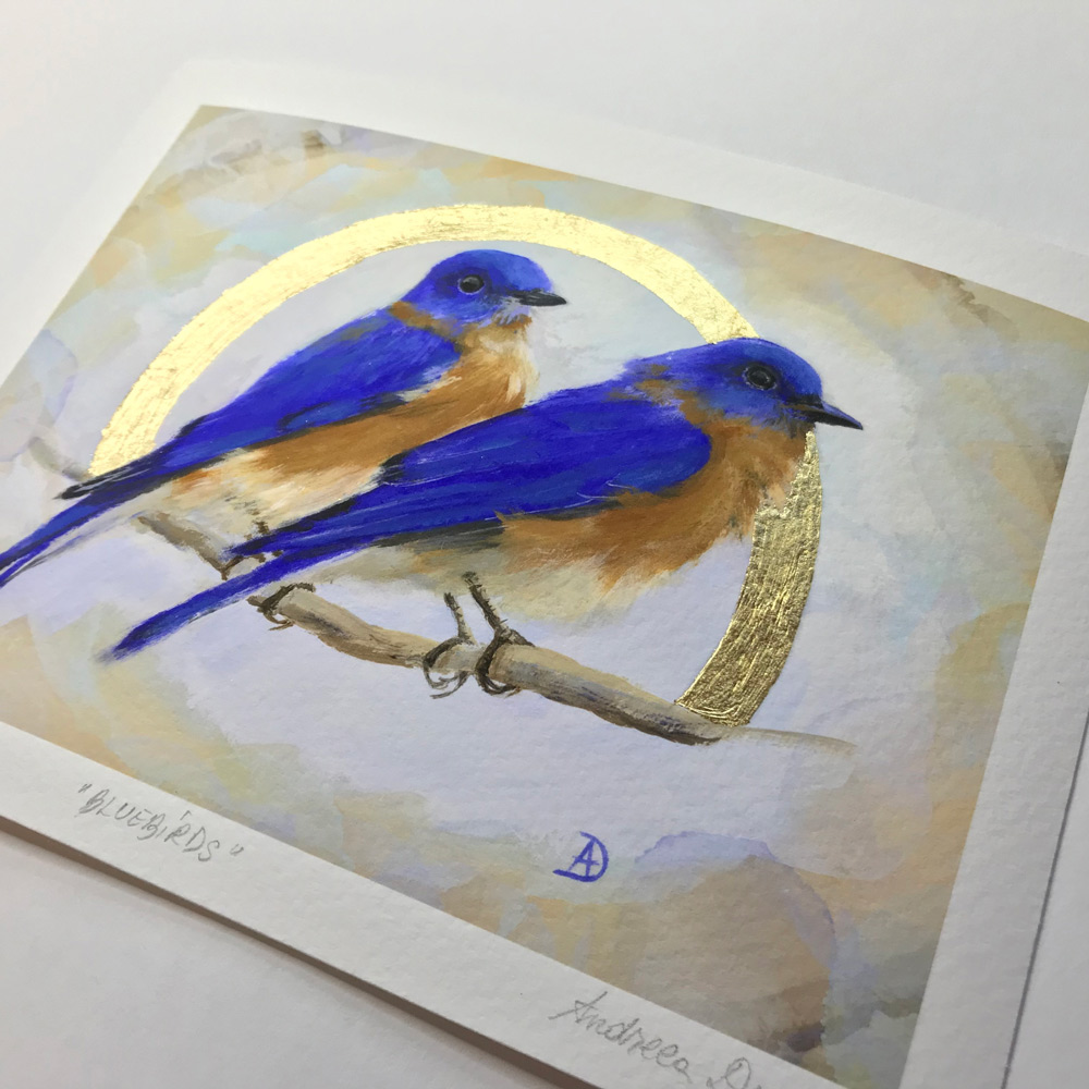 Art print of a pair of bluebirds surrounded by an aura of gold leaf